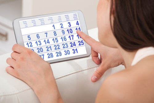 Woman pointing on a calendar the day of her menstruation