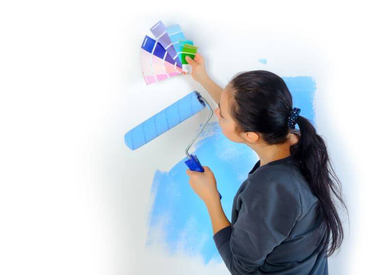 Woman painting a wall