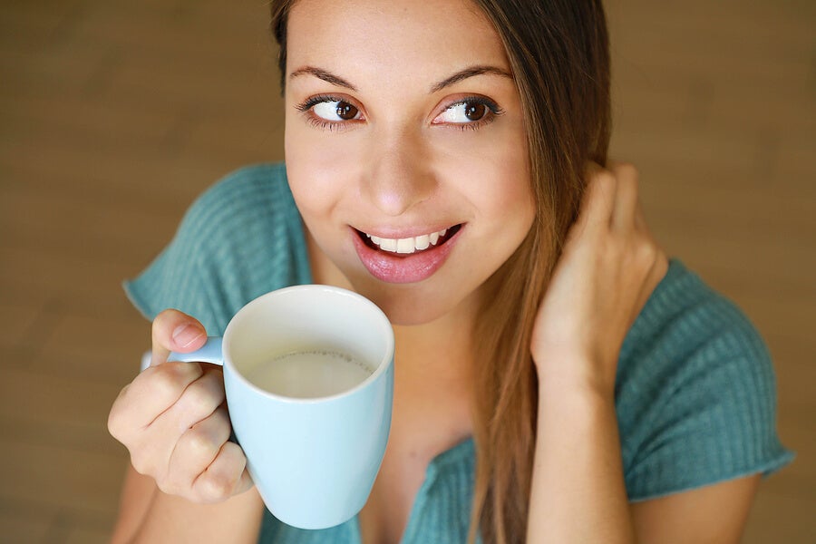 Woman drinking milk from a cup.