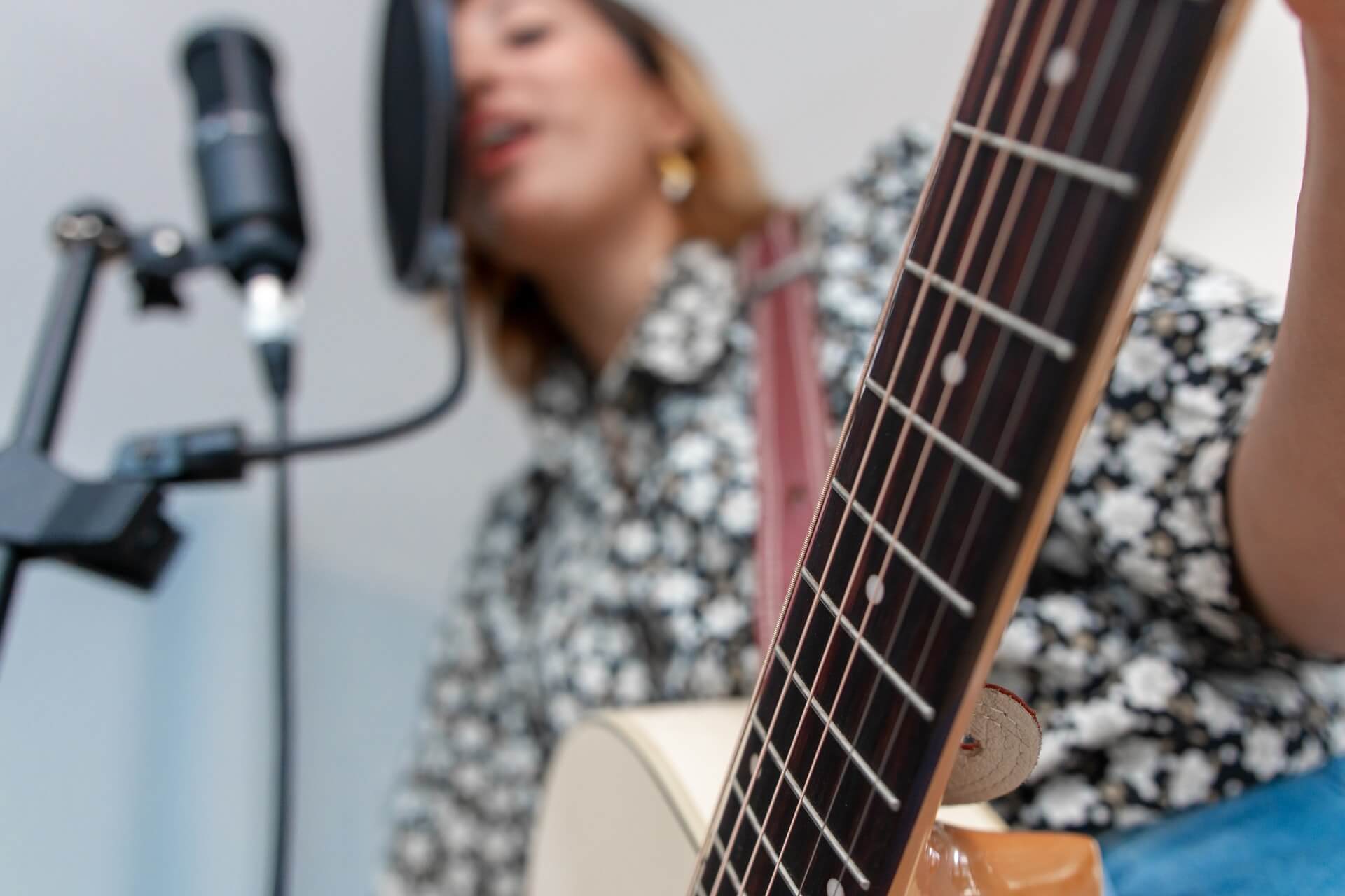 Woman singing and playing guitar