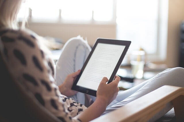 Woman reading on her tablet.