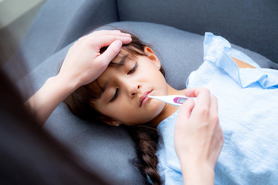 Girl with fever and thermometer