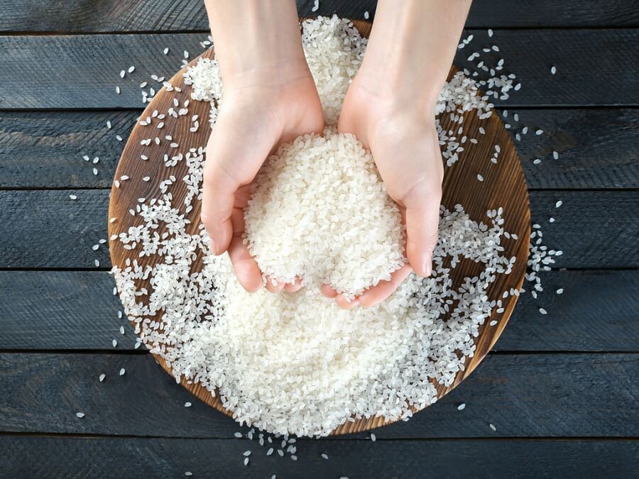 hands picking up rice