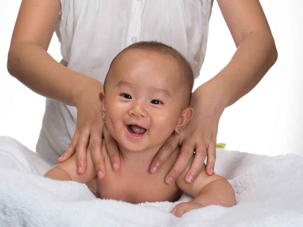 Mother giving a massage to her son to activate the senses.