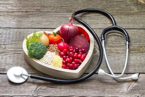 Food in a heart-shaped bowl and a stethoscope